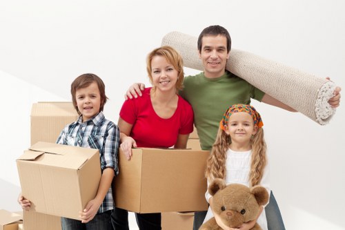 Moving professionals handling boxes and furniture during a Kennington relocation