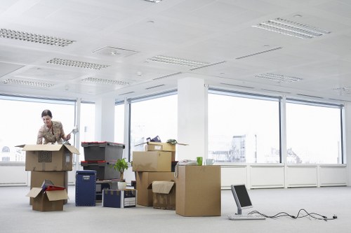 Movers handling furniture and boxes in a Kennington flat move