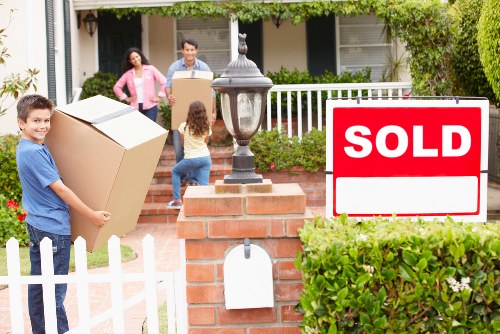 Local movers organising packed items for a South London relocation