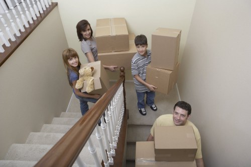 Packed moving boxes and furniture ready for transport in Kennington